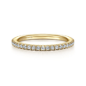 Gabriel & Co. WB14914O2Y44JJ 14 karat yellow gold Contemporary wedding band, front view of a straight hoop with round diamonds in fine prongs running toward both ends