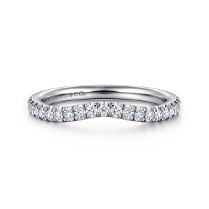 Gabriel & Co. WB16337E12W44JJ 14 karat white gold Contemporary wedding band, front view of the curved row of round diamonds with a maker's mark inside