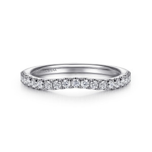 Gabriel & Co. WB16435O6W44JJ 14 karat white gold Contemporary wedding band, front view of a shallow dip in the stone line with tiny prongs between round diamonds