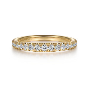 Gabriel & Co. WB16520R6Y44JJ 14 karat yellow gold Contemporary wedding band, front view of round diamonds between tiny prongs, with a maker's mark on the inside wall