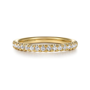 Gabriel & Co. WB16527R8Y44JJ 14 karat yellow gold Contemporary wedding band, front view of round diamonds between small rounded prong tips with a maker's mark inside the band