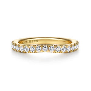 Gabriel & Co. WB16690E12Y44JJ 14 karat yellow gold Contemporary wedding band, front view of a band with a gentle dip along its stone row and small prongs between stones