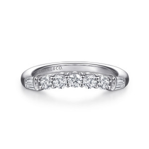 Gabriel & Co. WB16701O8W44JJ 14 karat white gold Contemporary wedding band, front view of a curved line of round stones ending in a pair of tapered baguettes