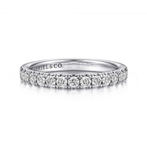 Gabriel & Co. WB16738R8W44JJ 14 karat white gold Contemporary wedding band, front view of round diamonds between small upright prongs with a maker's mark inside the hoop
