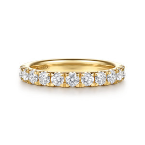 Gabriel & Co. WB16935E8Y44JJ 14 karat yellow gold Classic wedding band, front view of round diamonds lined up in a straight row between tall shared prongs