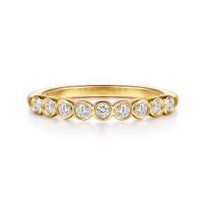 Gabriel & Co. WB16968R8VY44JJ 14 karat yellow gold Contemporary wedding band, front view of round diamonds in touching bezels across the front, the outer ones turning down the sides