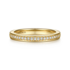 Gabriel & Co. WB17419O8Y44JJ 14 karat yellow gold Contemporary wedding band, front view of tiny round diamonds with small prongs along one edge of a straight hoop