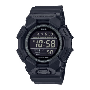 Casio G-Shock GD010-1A1 watch, front view of the round screen, gray printed ring and crossed raised patch at the bottom