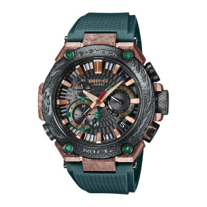Casio G-Shock MR-G MRGB2000KT-3A watch, front view of the hammered dark bezel, copper tone corners and four green round stones