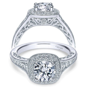 Taryn TE7294W44JJ 14 karat white gold engagement ring, front view of a round center in a cushion shaped double halo over pierced filigree and graduated shoulders