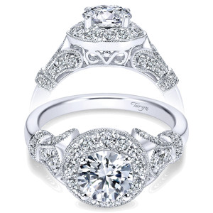 Taryn TE7478W44JJ 14 karat white gold engagement ring, front view of a round center in a milgrain edged cushion halo above scrolled pave shoulders