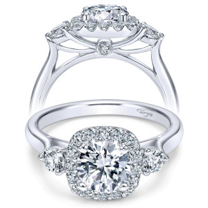 Taryn TE7510W44JJ 14 karat white gold engagement ring, front view of a round center in a cushion halo flanked by round side stones, plain tapered shank
