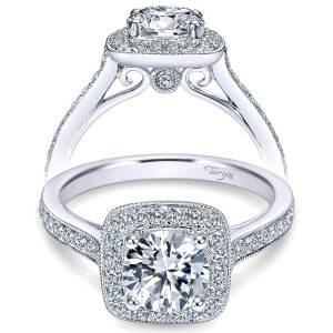 Taryn TE7525W44JJ 14 karat white gold engagement ring, front view of a round center in a milgrain cushion halo with pave shoulders and scrolled gallery