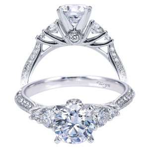 Taryn TE7539W44JJ 14 karat white gold engagement ring, front view of a round center flanked by graduated round side stones above pave shoulders and bezel accent