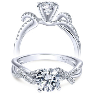 Taryn TE7756W44JJ 14 karat white gold engagement ring, front view of a round center lifted above wave shaped shoulders with pave along the outer curves