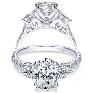 Taryn TE9048W44JJ 14 karat white gold engagement ring, front view of an oval center between pear side stones, scrolled filigree gallery above a pave shank