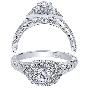 Taryn TE910421W44JJ 14 karat white gold engagement ring, two views of a round center in an elongated halo widened by side accents, engraved leaf shank