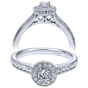 Taryn TE910945W44JJ 14 karat white gold engagement ring, two views of a round center in a rimmed halo above a milgrain edged stone row