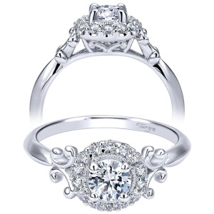 Taryn TE911777R0W44JJ 14 karat white gold engagement ring, front and side views of a round center in a single halo flanked by polished curl shoulders