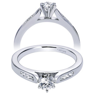 Taryn TE96352W44JJ 14 karat white gold engagement ring, angled view of a round center with channel set shoulder stones flanking a tapered shank