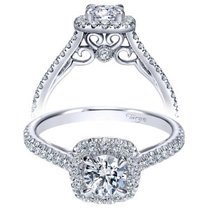 Taryn TE98520W44JJ 14 karat white gold engagement ring, front view of a round center in a cushion halo over scrollwork centered on a bezel accent
