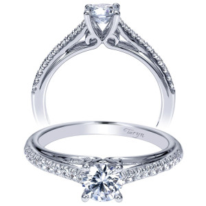 Taryn TE98556W44JJ 14 karat white gold engagement ring, front view of a round center on split pave rails meeting a polished center groove