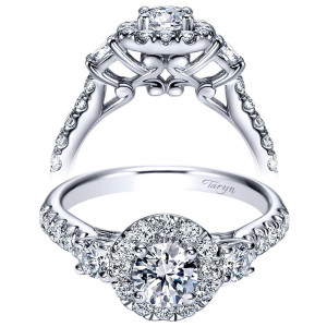 Taryn TE98580W44JJ 14 karat white gold engagement ring, front view of a round center in a halo flanked by single rounds above fleur openwork