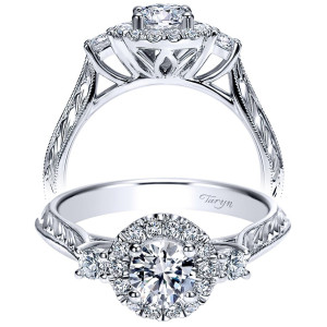 Taryn TE98581W44JJ 14 karat white gold engagement ring, front view of a halo framed round center with side rounds over engraved wheat shoulders
