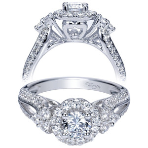Taryn TE98583W44JJ 14 karat white gold engagement ring, front view of a round center in a halo beside round clusters on crossing pave shoulders