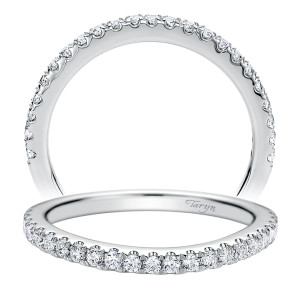 Taryn TW9783W44JJ 14 karat white gold wedding band, two views of a softly curved row of prong set round stones tapering toward the shoulders