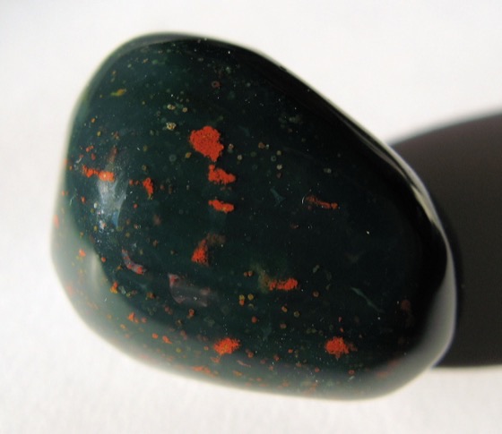A polished bloodstone, dark green with bright red spots
